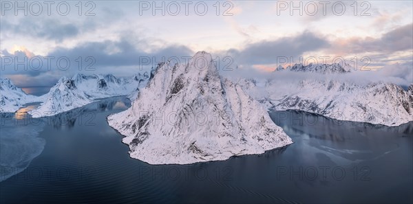 Snowy mountains by the fjord, Mount Olstinden, Reinefjord, Reine, Lofoten, Norway, Europe