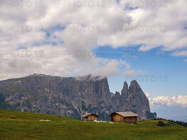 Alpine huts in front of the Sciliar, Punta Santner, Dolomites, Alpe di Siusi, South Tyrol, Italy,