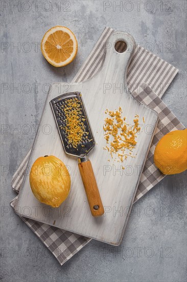 Grated lemon zest, on a cutting board, with a grater, top view, no people
