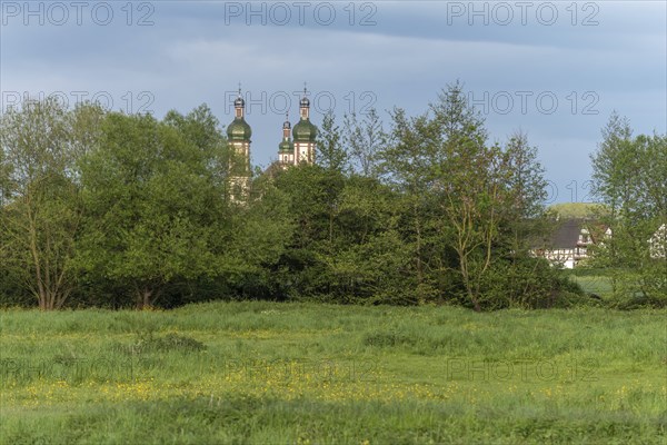 The baroque Saint-Maurice church in Ebersmunster surrounded by meadows in spring. Bas Rhin, Alsace,