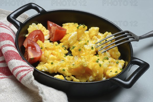 Scrambled eggs with tomatoes in a pan