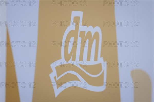 The logo of the drugstore chain DM is stuck on a window front in Berlin, 27/03/2024