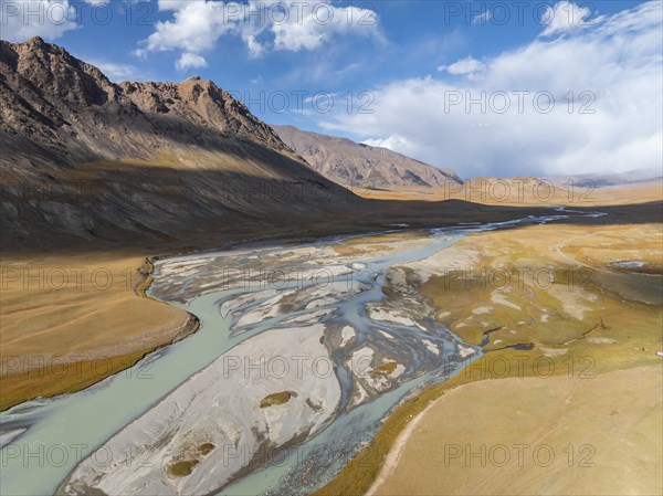 Aerial view, Burkhan mountain valley with meandering river, barren dramatic mountain landscape,