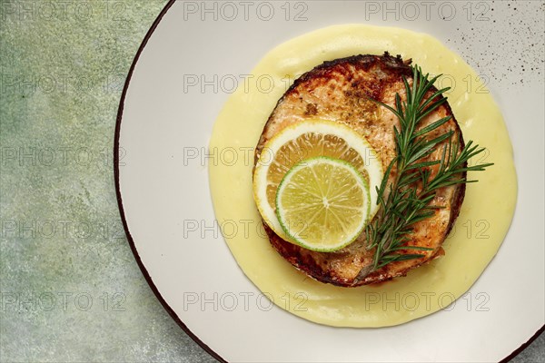 Salmon steak, fried, mashed potatoes, top view, rosemary, lemon and lime, homemade, one serving, no