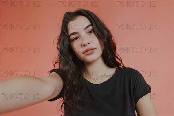 Young teenage girl taking selfie in front of pink studio background. KI generiert, generiert, AI