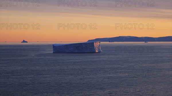 Iceberg seen from cruise ship vacation near Greenland coast in Arctic circle near Ilulissat Disko