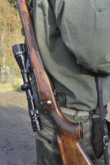 Hunter with shotgun and scope in the Ardennes, Belgium, Europe
