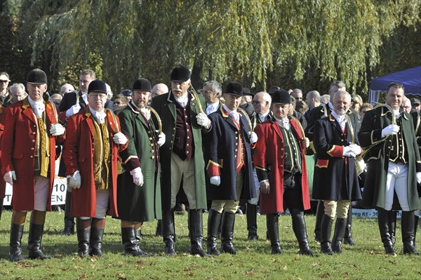 Huntsmen with hunting horns at drag hunting demonstration in Belgium