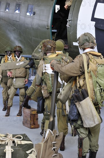 Uniforms of American soldiers and Douglas C-47 aircraft in the Airborne Museum in