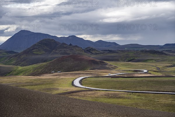 Road through volcanic landscape with colourful hills, Krafla geothermal area, Northern Iceland,