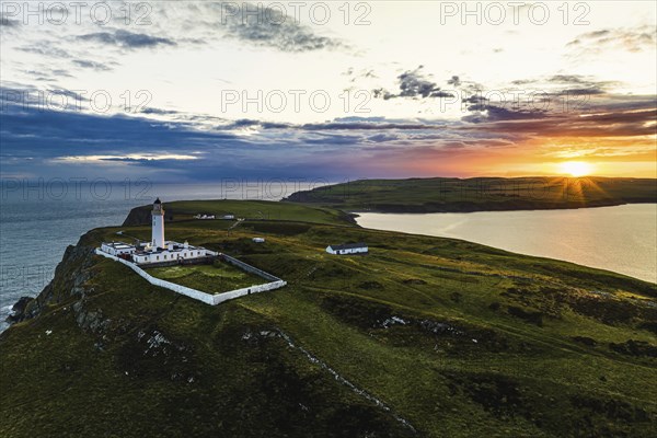 Sunset over Mull of Galloway Lighthouse from a drone, Mainland Scotland, Scotland, UK