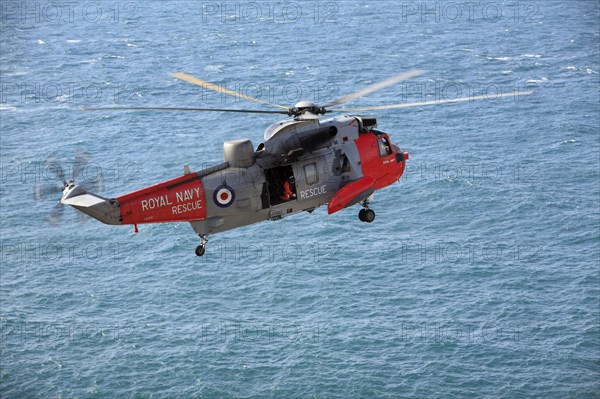 Royal Air Force, rescue helicopter in action above the sea, Cornwall, England, United Kingdom,