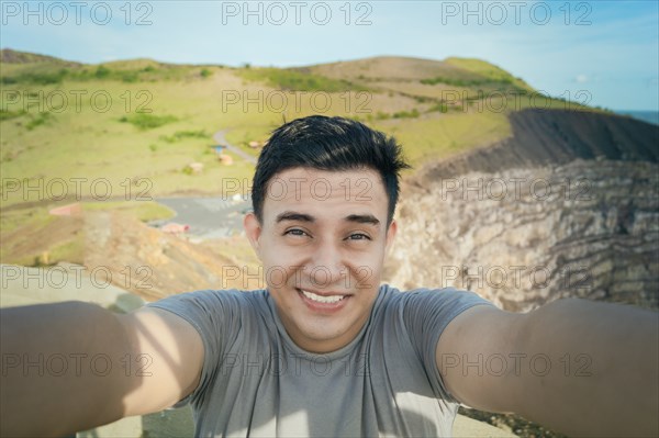 Adventurous man taking a selfie at a viewpoint. Close up of person taking an adventure selfie,