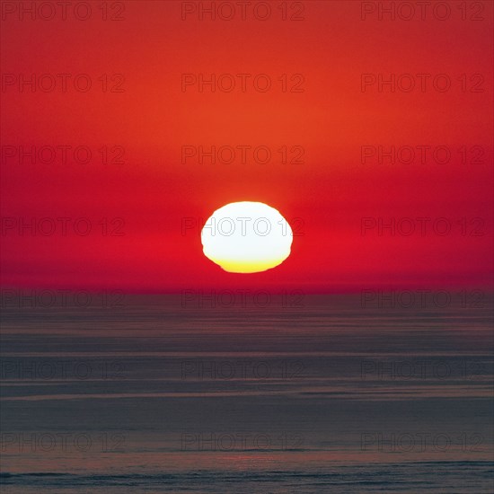 Reflection at sunset, deformation, unusual deformation in haze, Bassin d'Arcachon, Bay of Biscay,