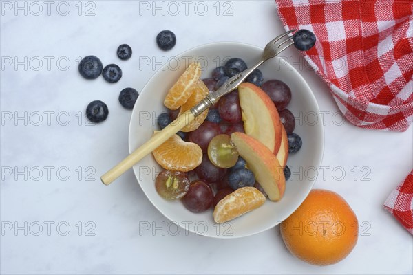 Various pieces of fruit in bowl, fruit salad