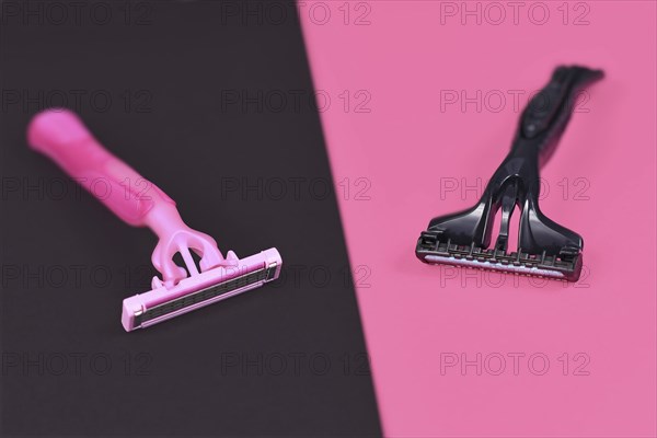 Gender stereotypes concept showing pink and black razor aimed at specific genders