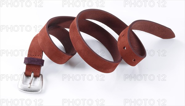 Leather belt in front of a white background, studio shot