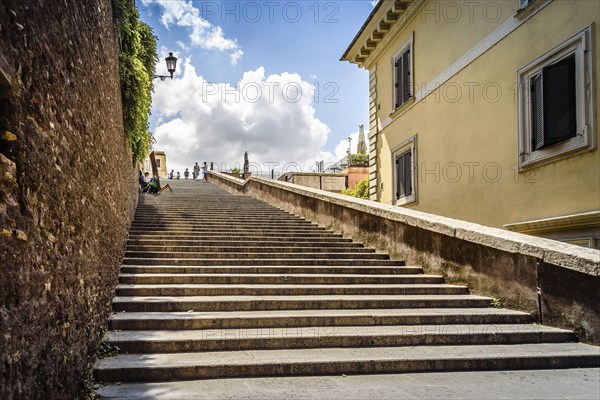 Rome, Italy, August 18, 2016: Lateral staircase to Piazza della Trinita dei Monti with artist