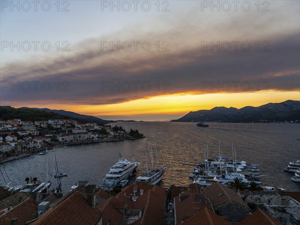 Evening atmosphere at sunset by the sea, view from the bell tower, Korcula harbour, Korcula island,