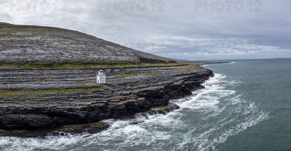 An aerial view of the Burren Coast in County Clare with the Black Head Lighthouse on the rocky
