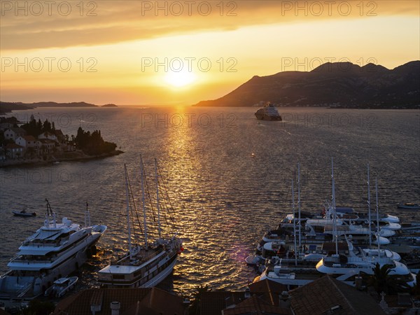 Evening atmosphere at sunset by the sea, view from the bell tower, ships in Korcula harbour,