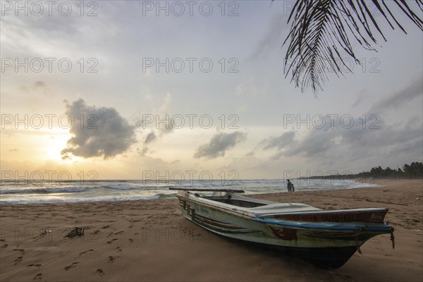 Landscape by the sea and sandy beach. A boat lies in the sand and adds a special touch to the