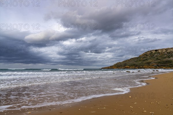 Landscape view of the red sand beach in idyllic Ramla Bay on Gozo Island in Malta