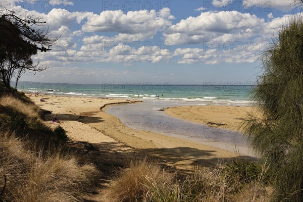 Beachgoers enjoy the surf, the refreshing water, the sun and the sand at the mouth of the Erskine