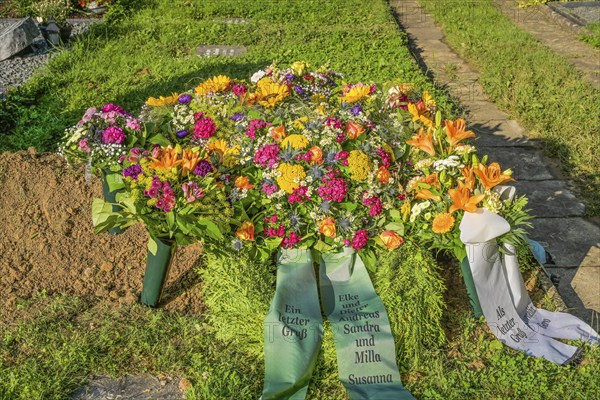 Flowers on a fresh grave in the cemetery