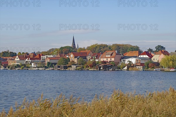 Picturesque town view at the lake with red roofs and nature, island town, Malchow,
