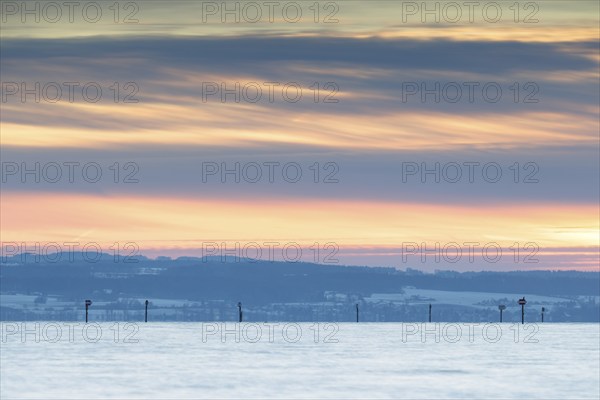 A calm sunset with a pastel-coloured sky over a vast landscape, harbour, Immenstaad, Lake