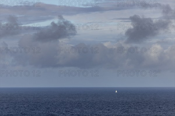 View over the sea to the horizon, clouds and white sailing ship, Mainland Orkney, Scotland, Great