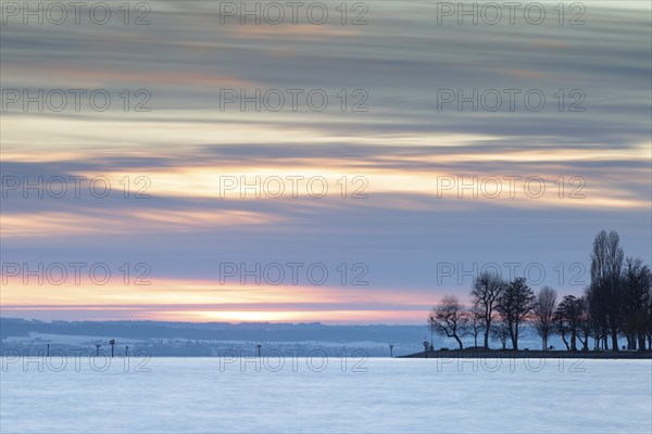 A picturesque sunset over a lake with trees and a colourful sky, harbour, Immenstaad, Lake