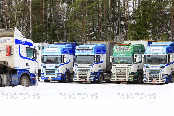 Beautifully customized Scania trucks L. Retva Oy parked at depot on a Sunday morning in winter.
