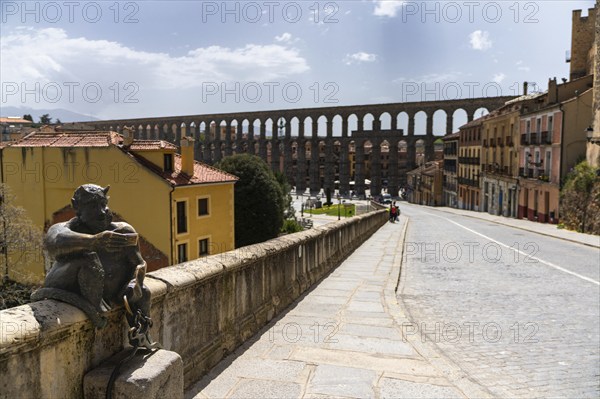 Segovia, Spain, 7 April, 2024: view of the devil statue and the aqueduct of Segovia in the