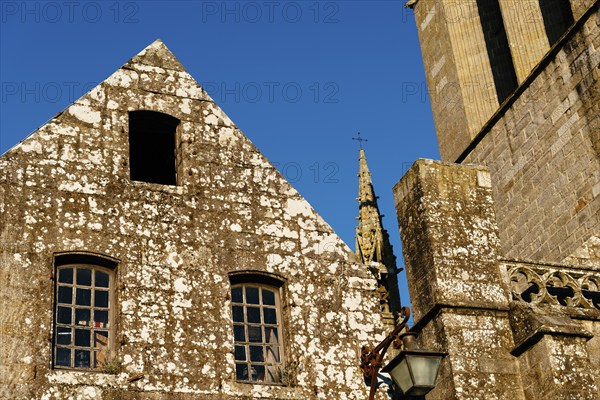 Close up detail of the facade of the churh of Saint Ronan in Locronan against blue sky