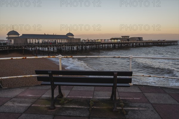 Hastings, East Sussex, England, UK, May 11, 2022: Evening mood on the beach, with a bench