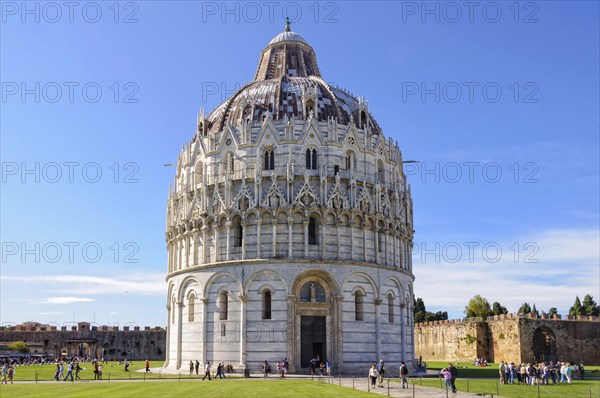Tourists visit the Baptistery (Battistero) on the Square of Miracles (Campo dei Miracoli) in Pisa,