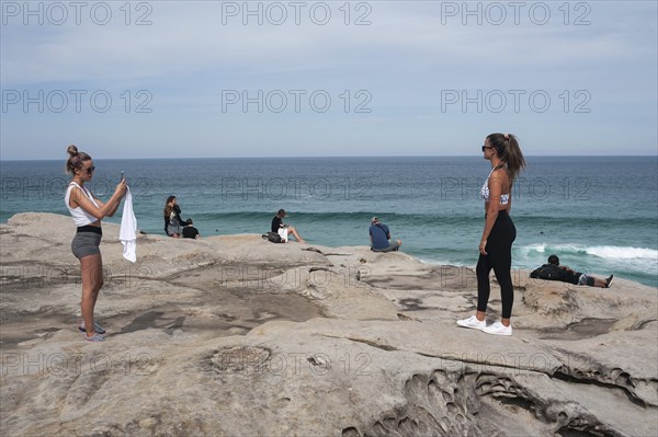 27.09.2019, Sydney, New South Wales, Australia, A young woman takes a photo of her girlfriend on