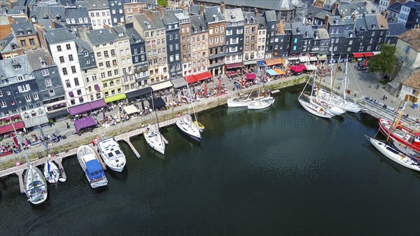 Fantastic drone point of view on Normandian ancient Honfleut town with harbor of sailboats and