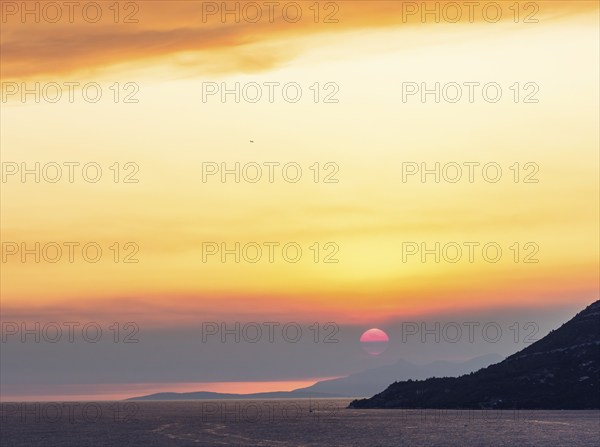 Cloudy mood at sunset by the sea, view from the bell tower, near Korcula, Korcula Island, Dalmatia,