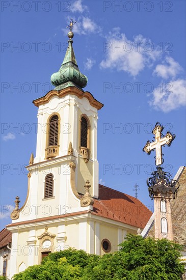 Memorial cross and the bell tower of the St John Roman Catholic Parish Church, Szentendre, Hungary,