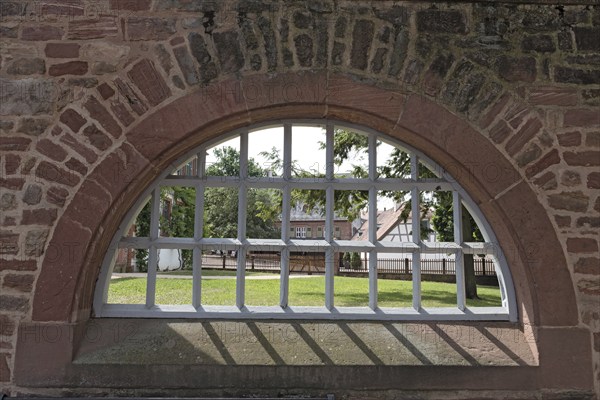 Monastery wall with iron lattice window, Seligenstadt, Hesse, Germany, Europe