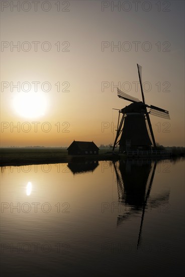 Achtkante mill near Groot-Ammers in the Dutch region Alblasserwaard in backlight
