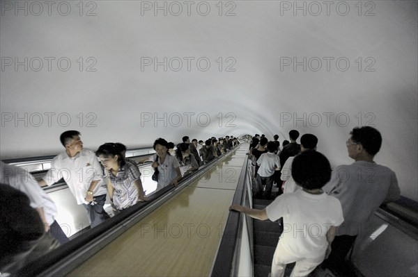 09.08.2012, Pyongyang, North Korea, Asia, Commuters on an escalator leading to an underground