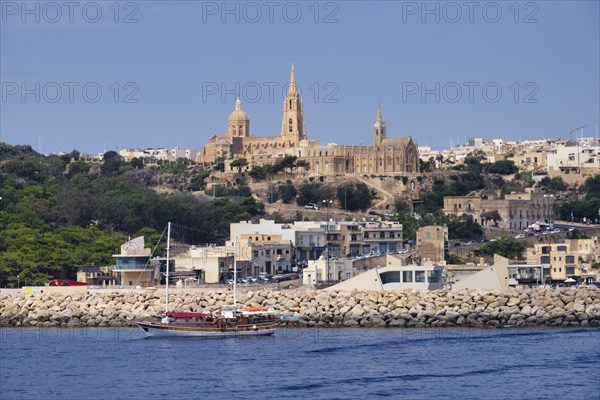 The Ghajnsielem Parish Church and the Our Lady of Lourdes Church high above the harbour, Mgarr,