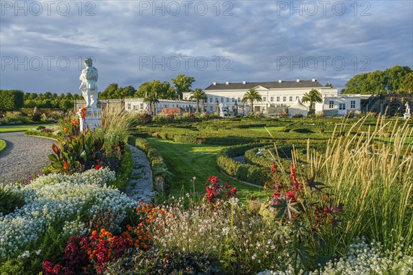Fantastic Herrenhausen gardens of Hannover with statue and luxury colorful flowerbeds with shiny