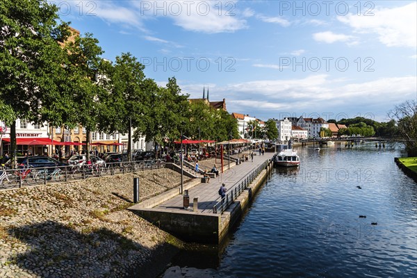 Lubeck, Germany, August 3, 2019: Scenic view of Trave River and waterfront in the old harbour,