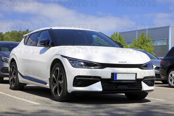 White Kia EV6 fully electric crossover car parked at the new car dealership. Salo, Finland. June
