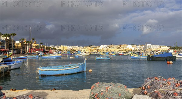 Marsaxlokk, Malta, 22 December, 2023: colorful fishing boats in the harbor of Marsaxlokk in